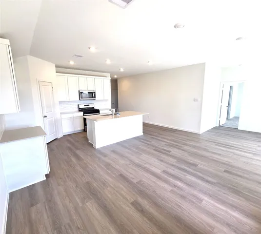 a view of kitchen with wooden floor