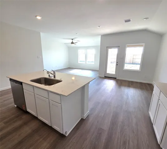 a kitchen with wooden floors and sink