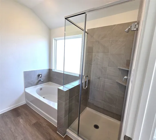 a bathroom with a bathtub and shower