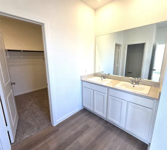 a bathroom with a double vanity sink and mirror