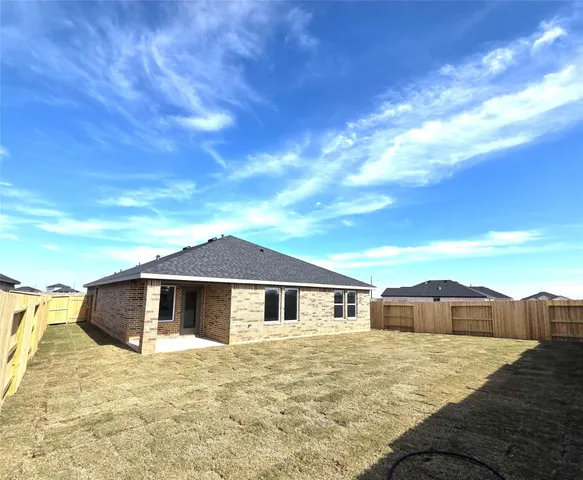 a group of people sitting in a backyard