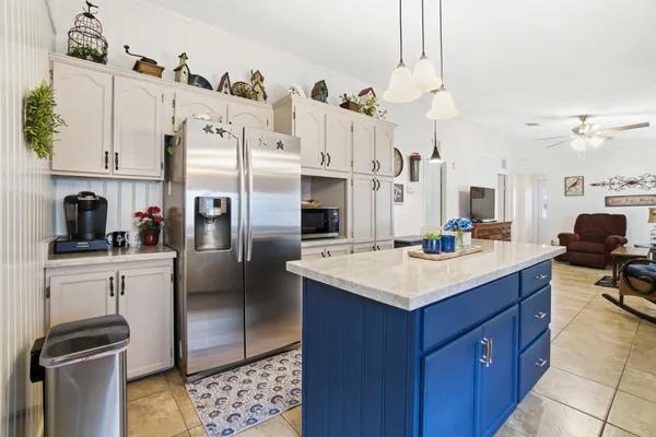 a kitchen with a sink appliances and cabinets