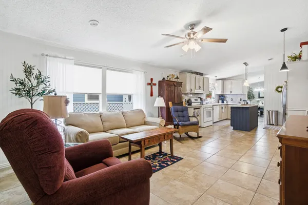 a living room with furniture and kitchen view