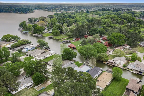 an aerial view of lake residential house with outdoor space and trees