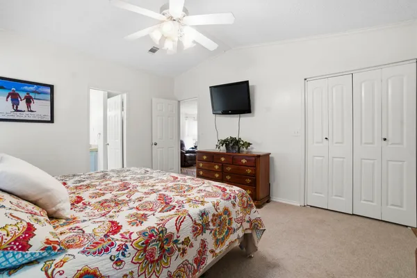 a bedroom with a bed and a flat screen tv
