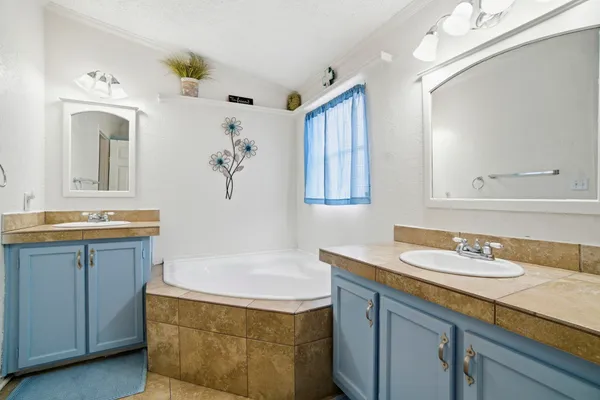 a bathroom with a granite countertop sink a mirror a and a