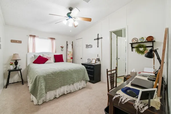a bedroom with a bed and a chandelier