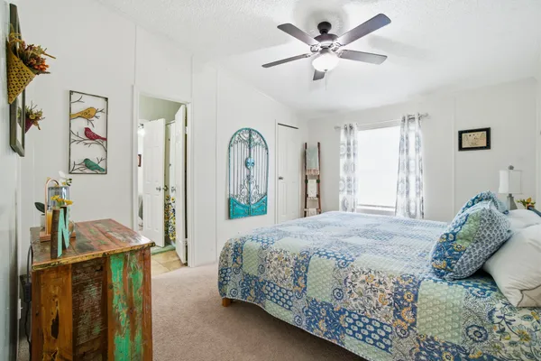 a bedroom with a large bed and a chandelier