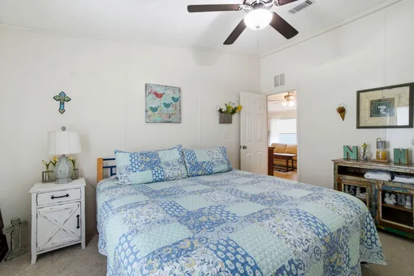 a bedroom with a bed and a chandelier