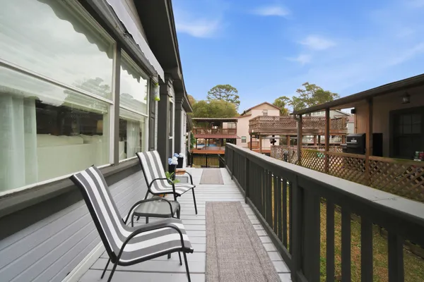 a view of a balcony with furniture