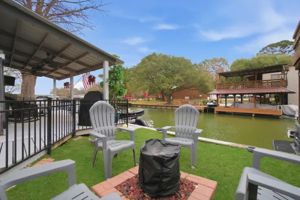 a front view of a house with swimming pool garden and patio