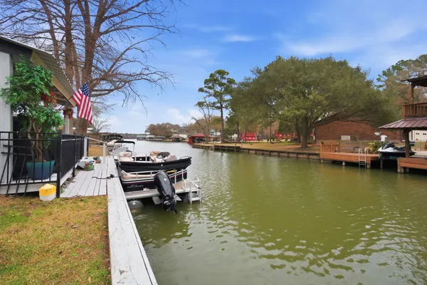a view of a lake with boats and trees around