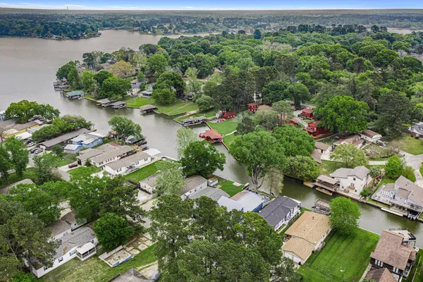 an aerial view of a houses with a lake view