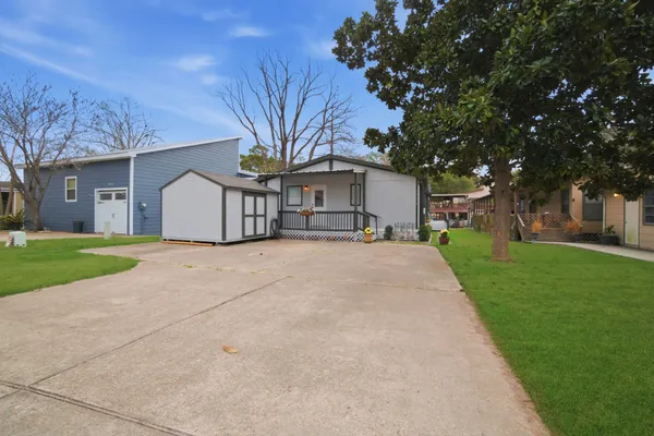 a view of house with yard and green space