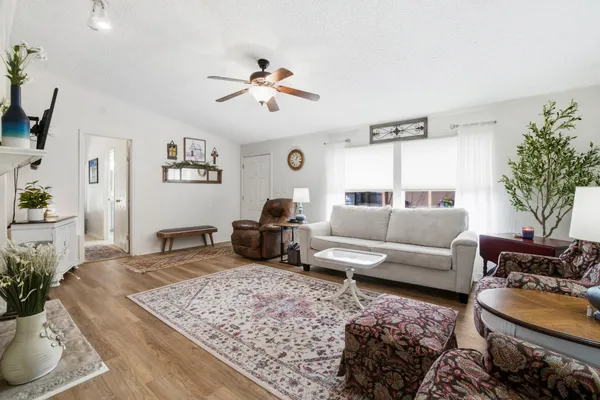 a living room with furniture and wooden floor