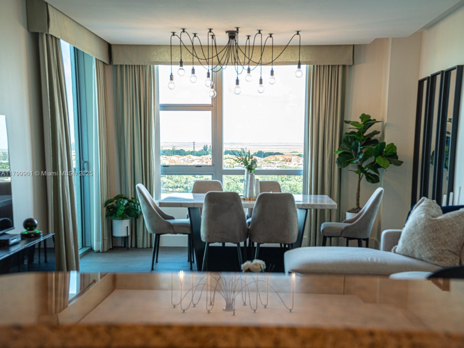 2681 North Flamingo Road, Unit 1206S Sunrise, FL 33323 - Photo 14 of 27 a living room with furniture large window and wooden floor