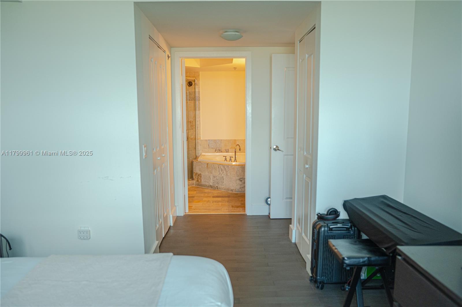 2681 North Flamingo Road, Unit 1206S Sunrise, FL 33323 - Photo 16 of 27 a bedroom with a bed and wooden floor