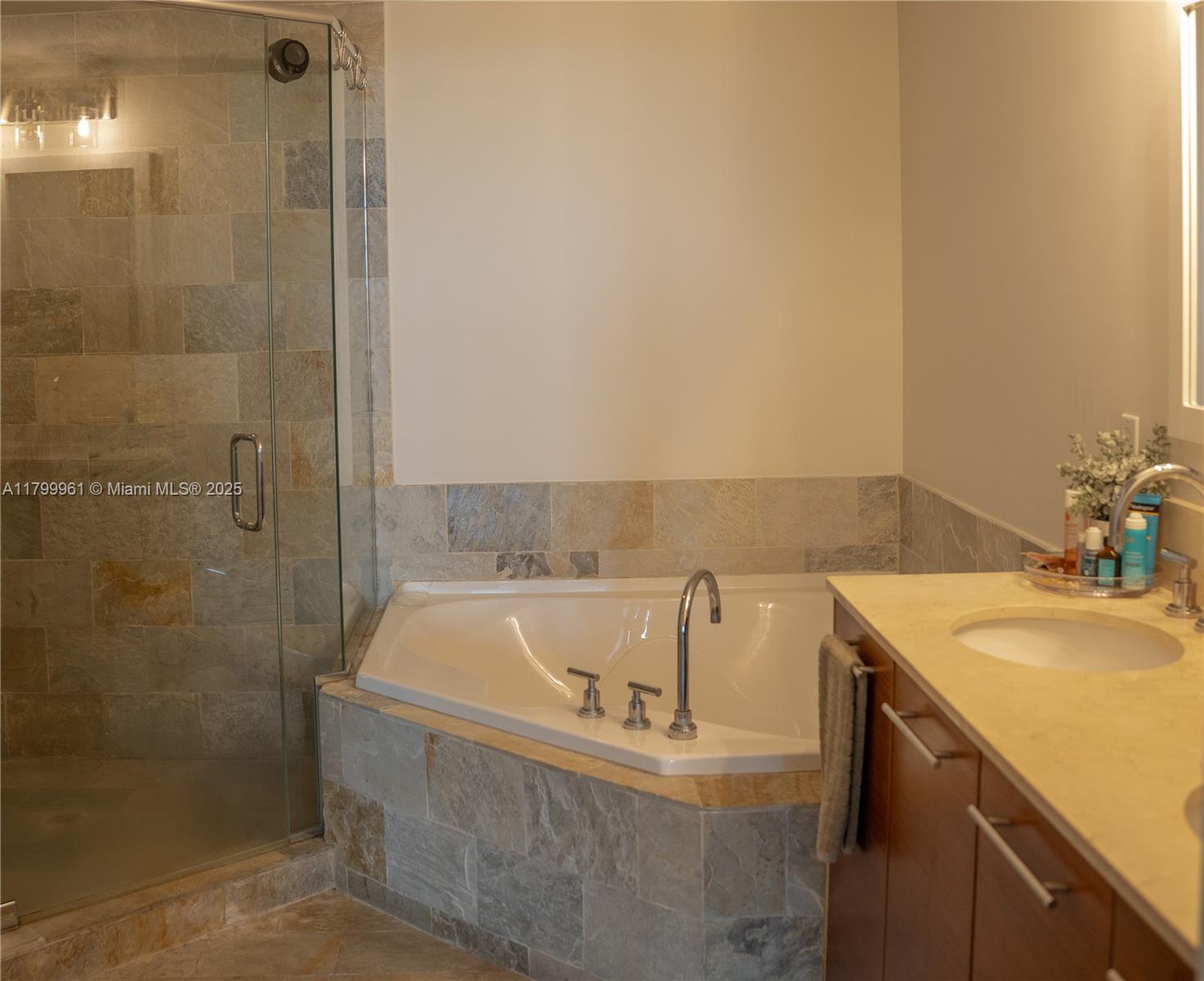2681 North Flamingo Road, Unit 1206S Sunrise, FL 33323 - Photo 17 of 27 a bath tub sitting next to a bathroom sink
