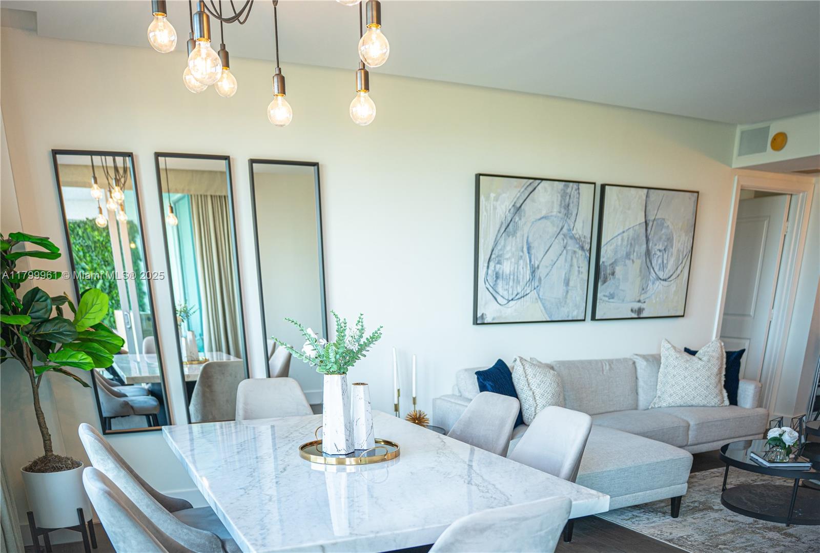 2681 North Flamingo Road, Unit 1206S Sunrise, FL 33323 - Photo 5 of 27 a dining room with furniture and a potted plant