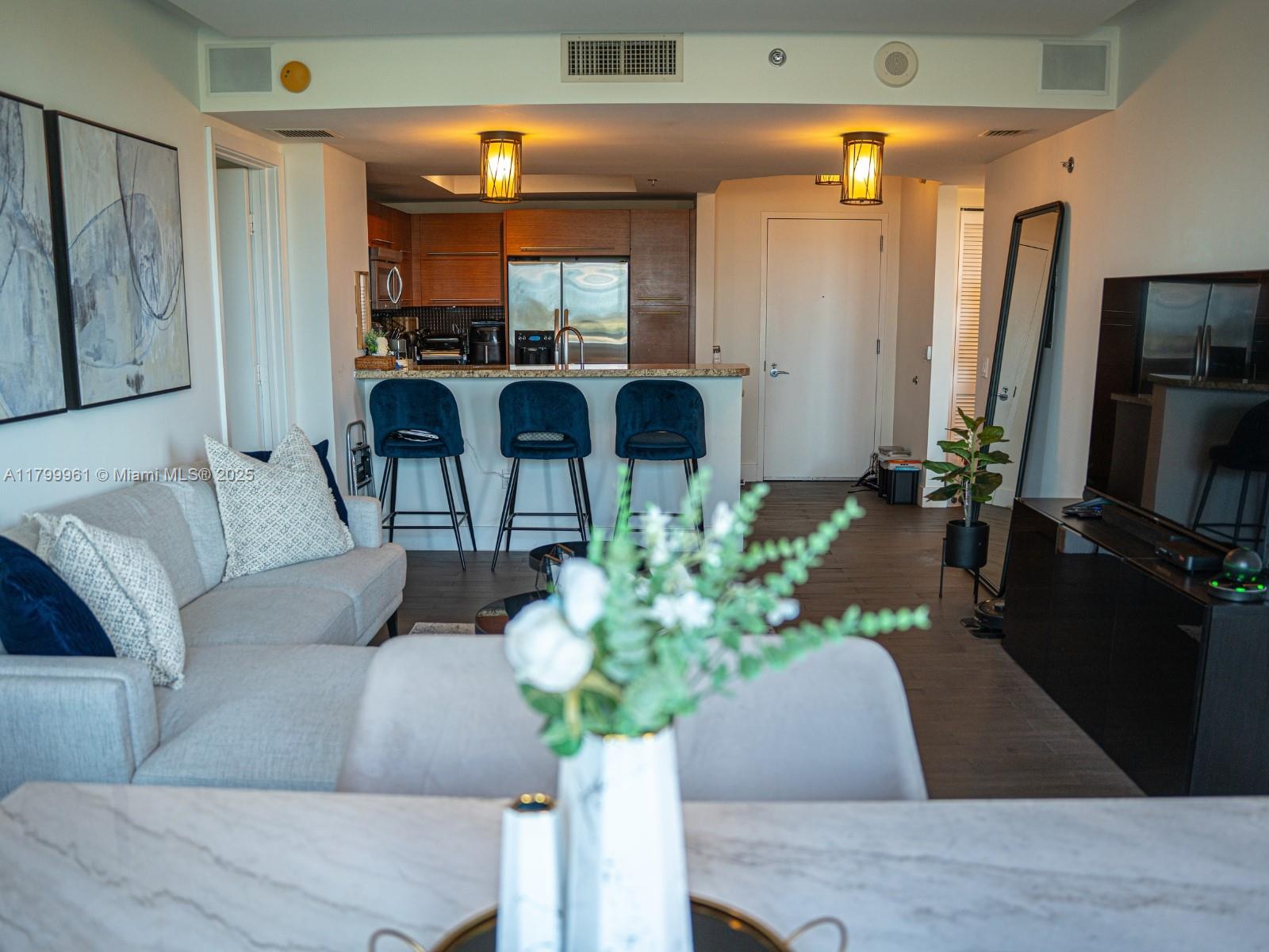 2681 North Flamingo Road, Unit 1206S Sunrise, FL 33323 - Photo 9 of 27 a living room with furniture potted plant and a large window