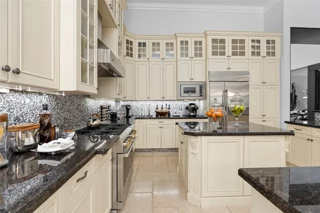 a kitchen with stainless steel appliances kitchen island granite countertop a sink and cabinets