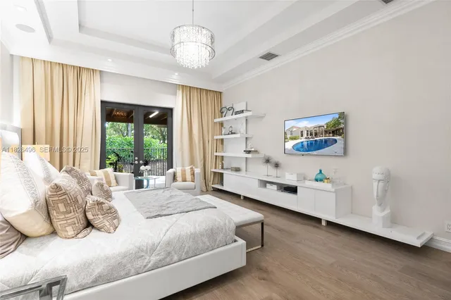 a bedroom with a bed and a chandelier