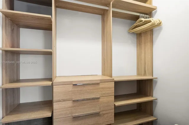 a bed room with a bed and a large window