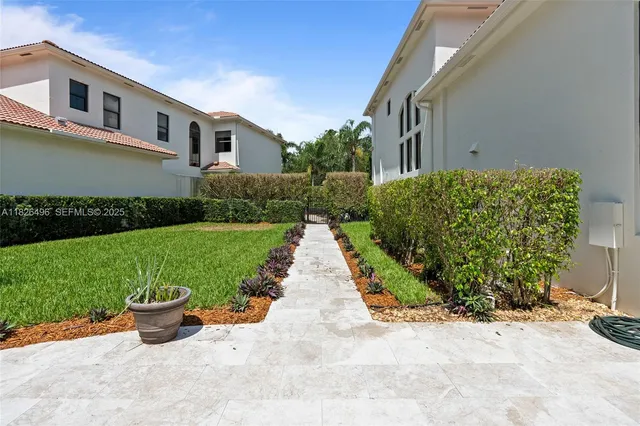 a view of a house with backyard and sitting area