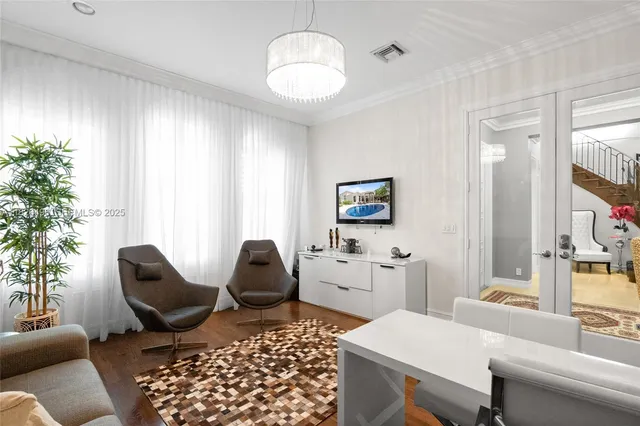 a living room with furniture and a chandelier