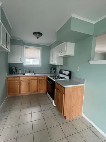 a kitchen with stainless steel appliances granite countertop a sink counter space cabinets and a window
