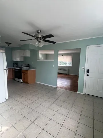 a view of a kitchen with a sink and a refrigerator