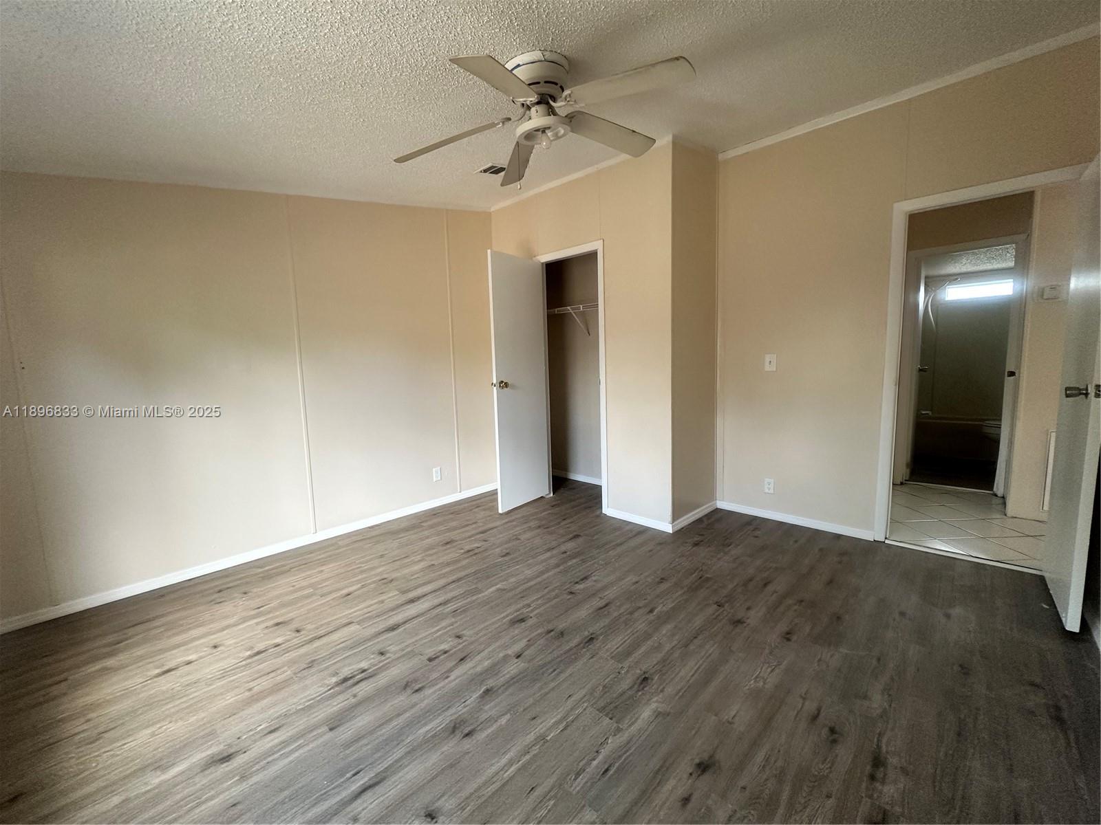 22844 Tradewind Road, Unit H Boca Raton, FL 33428 - Photo 11 of 16 wooden floor in an empty room with a window