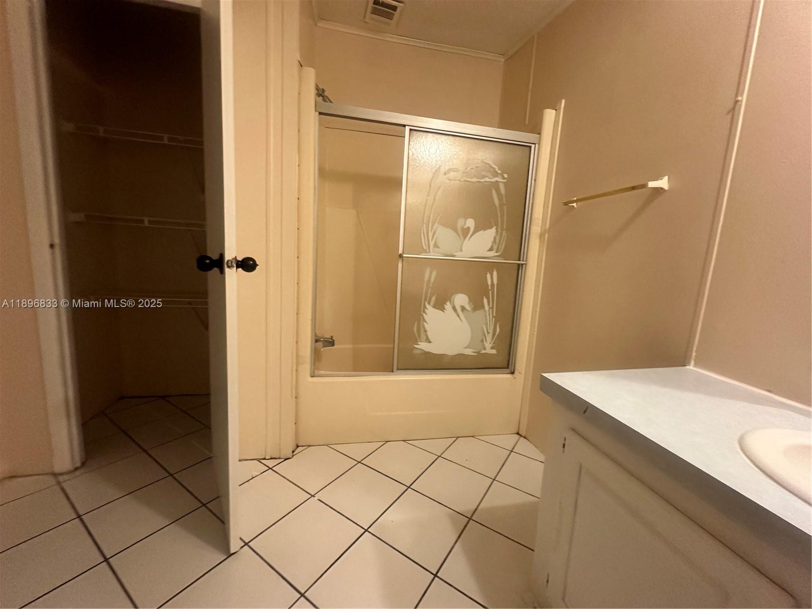 22844 Tradewind Road, Unit H Boca Raton, FL 33428 - Photo 6 of 16 a bathroom with a sink and a shower