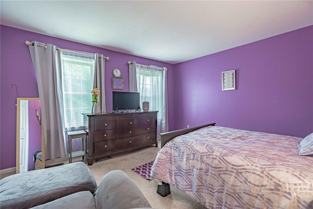 102 Sutton Road Easton, PA 18045 - Photo 48 of 83 Double windows frame this spacious bedroom, illuminating the soft carpeting throughout.
