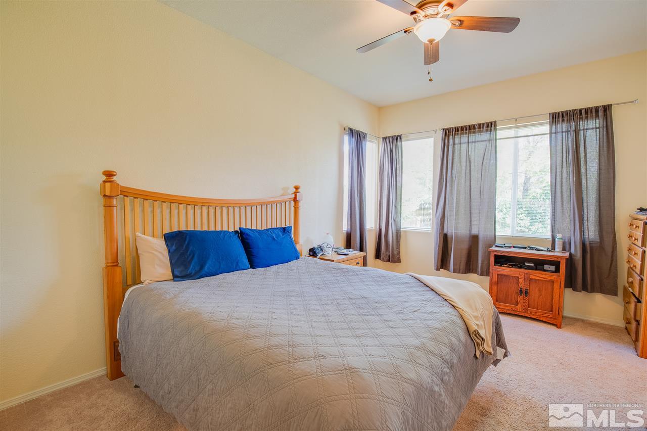 1735 Legacy Village Road Reno, NV 89521 - Photo 17 of 23 a large bed sitting in a bedroom next to a window