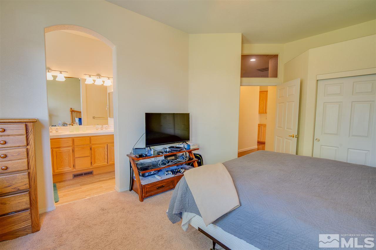 1735 Legacy Village Road Reno, NV 89521 - Photo 18 of 23 a bedroom with furniture and a flat screen tv
