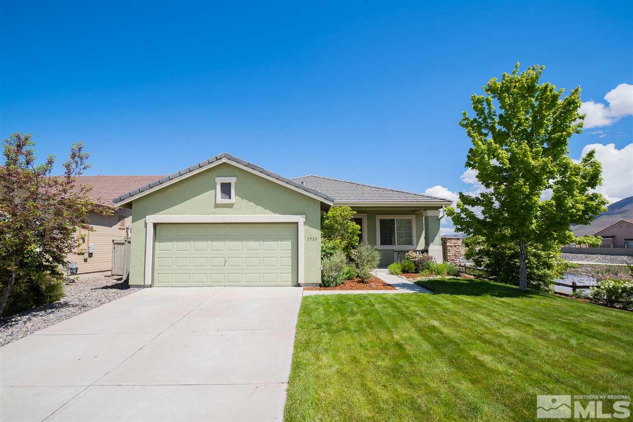 1735 Legacy Village Road Reno, NV 89521 - Photo 3 of 23 a front view of a house with a yard and garage