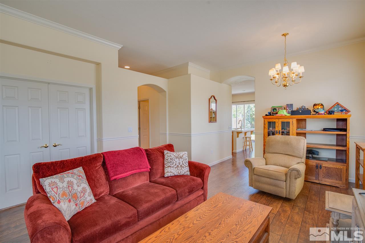 1735 Legacy Village Road Reno, NV 89521 - Photo 6 of 23 a living room with furniture and a chandelier
