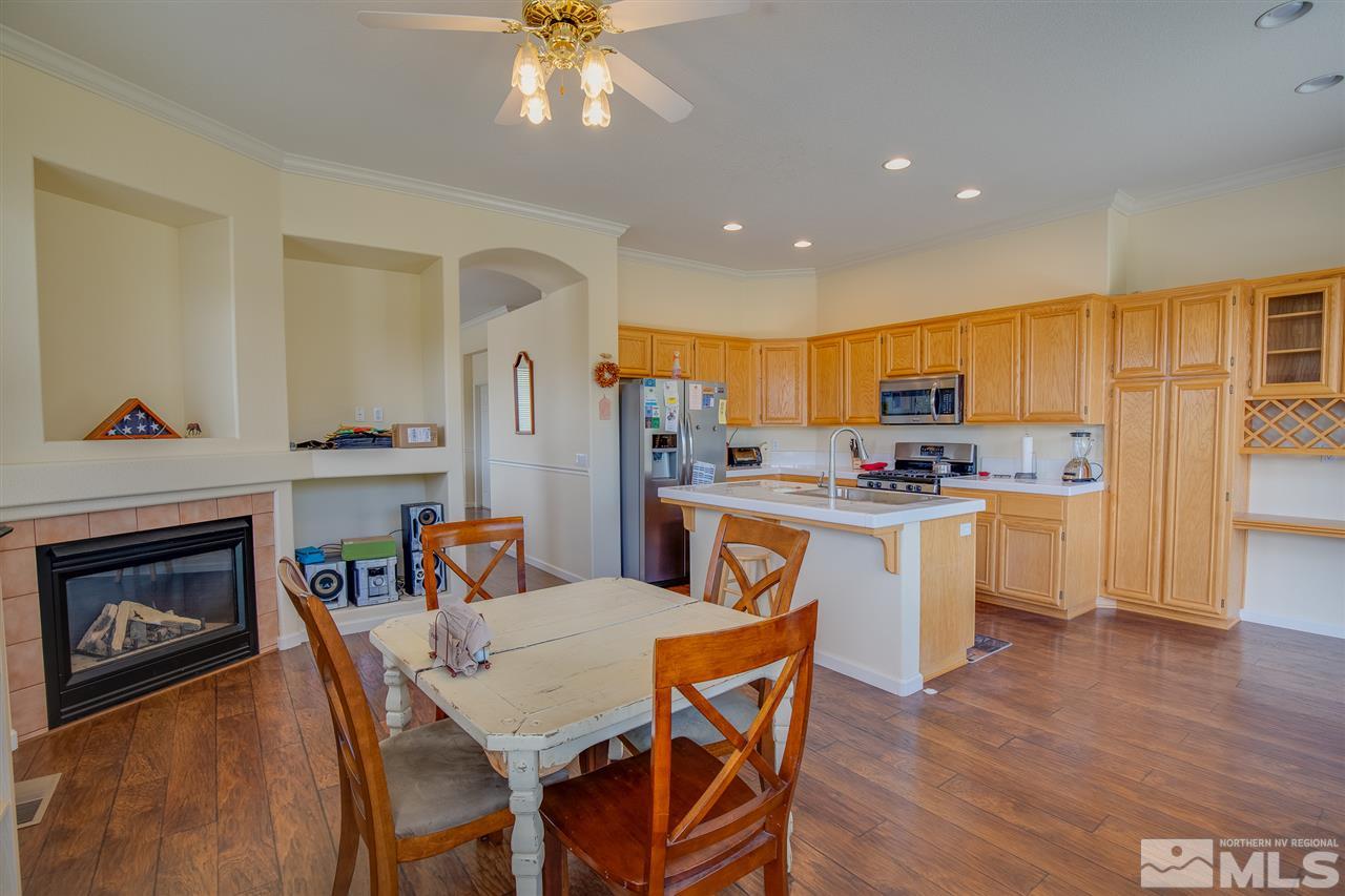 1735 Legacy Village Road Reno, NV 89521 - Photo 9 of 23 a kitchen with a table chairs refrigerator and cabinets
