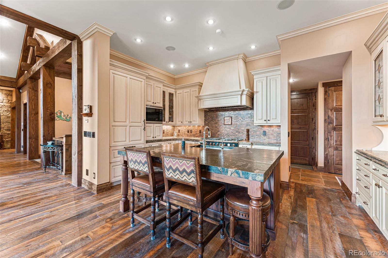 30 West Ranch Trail Morrison, CO 80465 - Photo 14 of 50 a large kitchen with dining table chairs and wooden floor