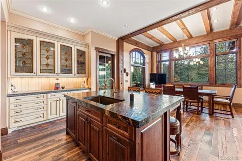 a kitchen with granite countertop a stove and a sink