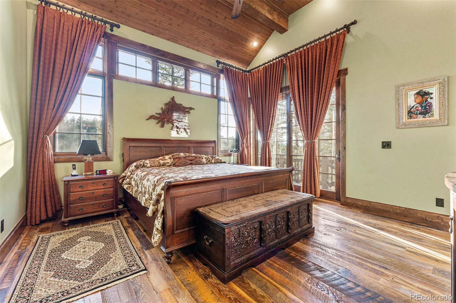 30 West Ranch Trail Morrison, CO 80465 - Photo 19 of 50 a bed sitting in a bedroom next to a window