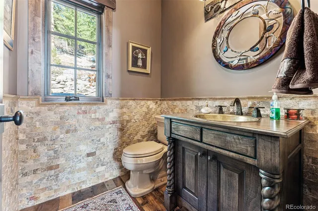 a bathroom with a sink a toilet and a mirror