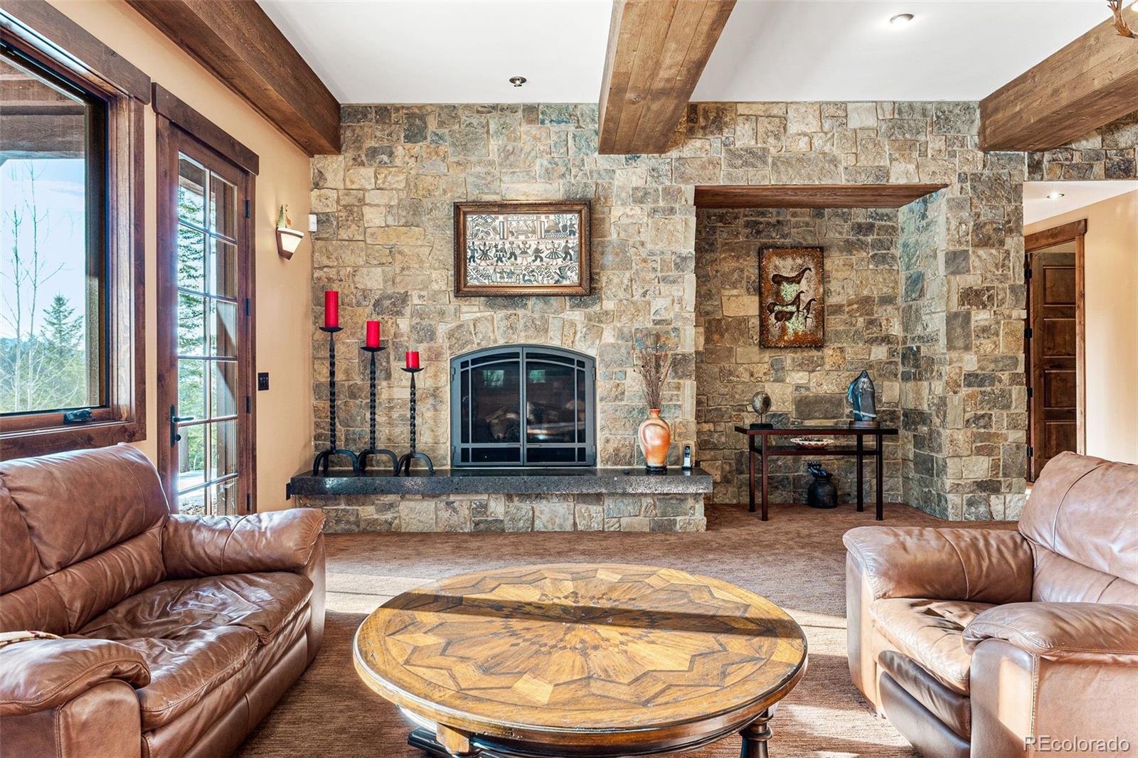30 West Ranch Trail Morrison, CO 80465 - Photo 27 of 50 a living room with furniture and a fireplace