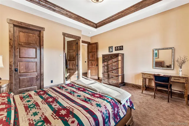 a bedroom with a bed and a bookshelf with wooden floor