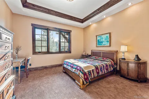 a bedroom with bed and wooden floor