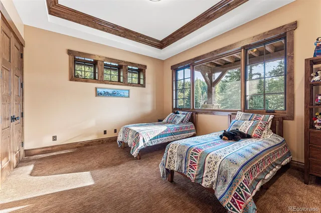 a bedroom with two beds and a large window