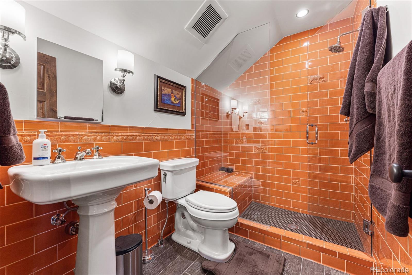 30 West Ranch Trail Morrison, CO 80465 - Photo 34 of 50 a bathroom with a sink a toilet and shower