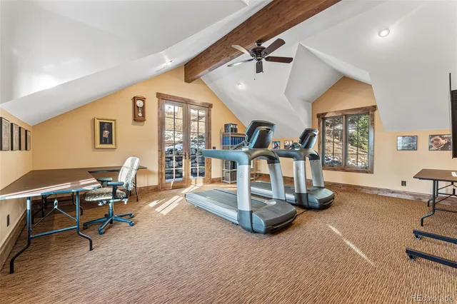 a view of a livingroom with furniture and a floor to ceiling window
