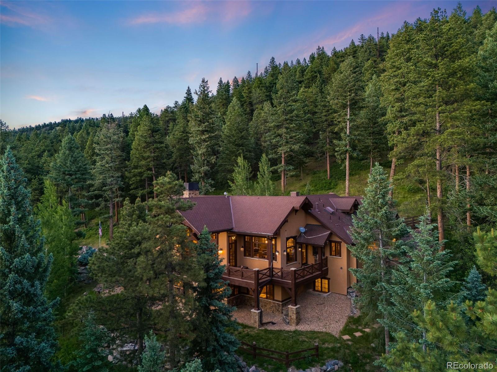 30 West Ranch Trail Morrison, CO 80465 - Photo 46 of 50 an aerial view of a house with yard table and chairs